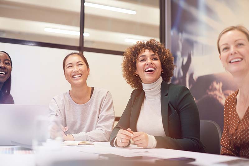 group of businesswomen sitting at a table during a class