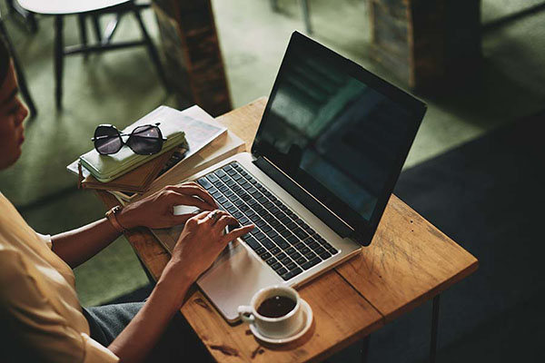 woman sitting at laptop taking virtual workshop