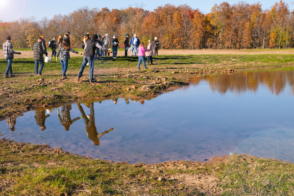 Students spread wild rice