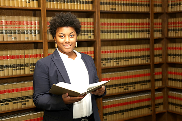 African American woman with law books