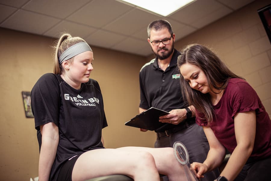 Professor overlooks student practicing on UWGB athlete