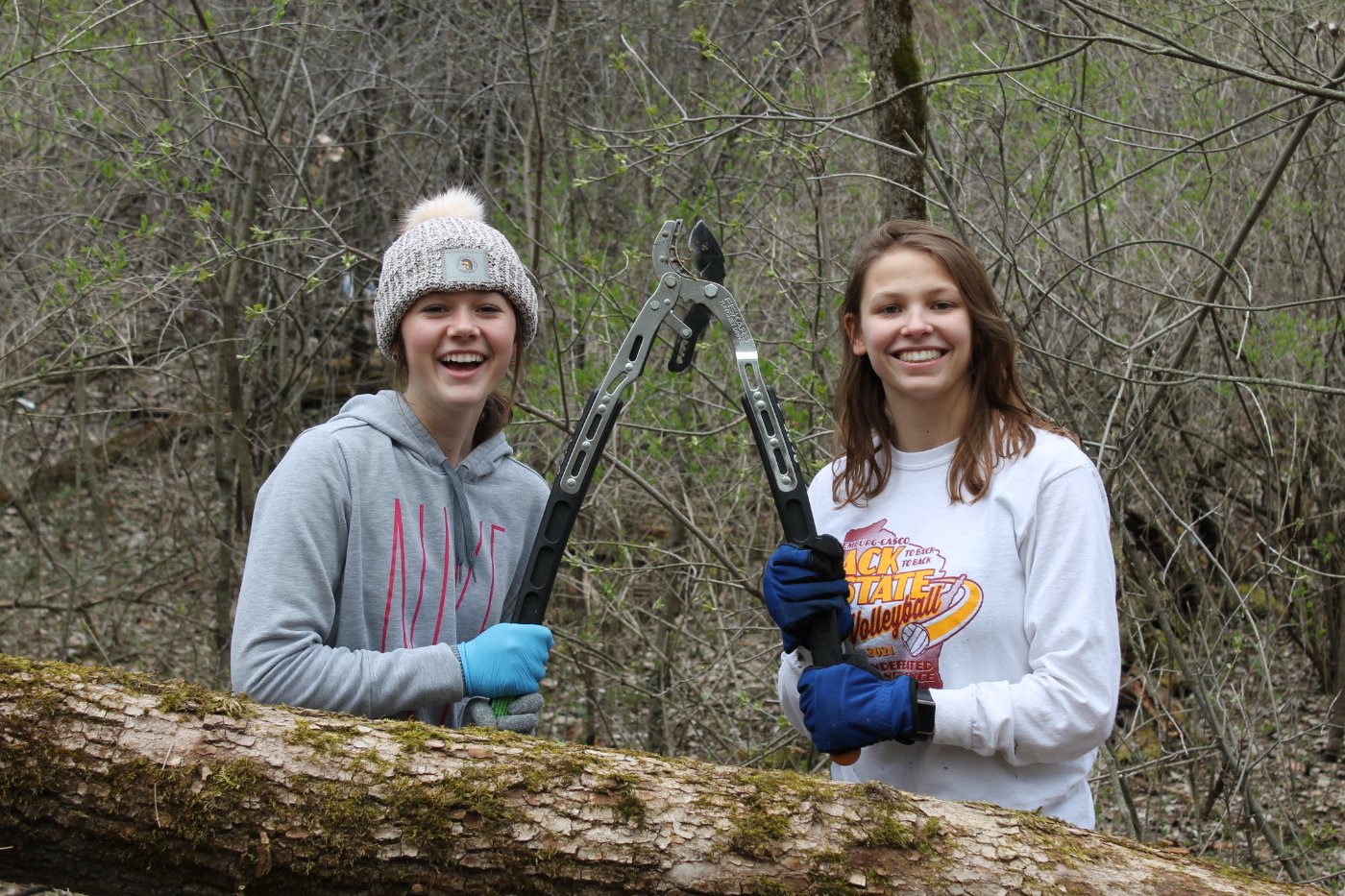 students hold up tree clippers