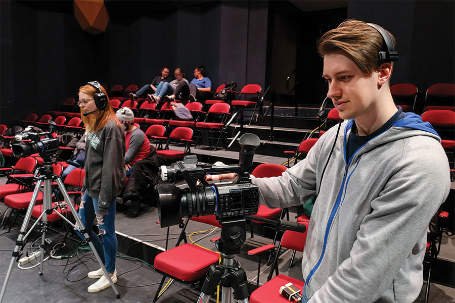 Two students using high-quality video cameras.