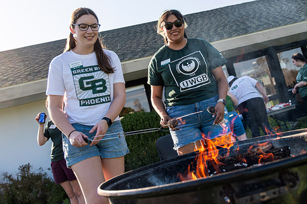 Two students roasting marshmallows