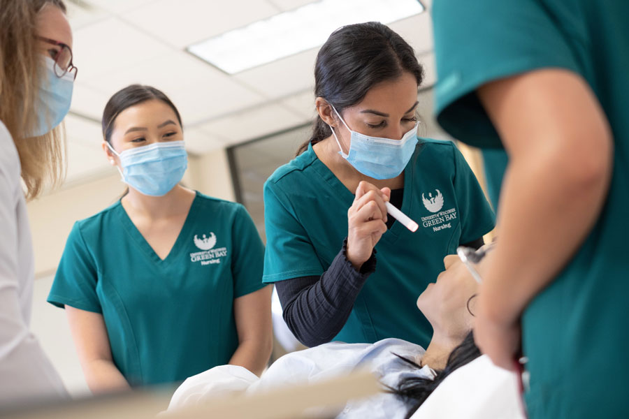 Nursing student and professor working in simulation lab