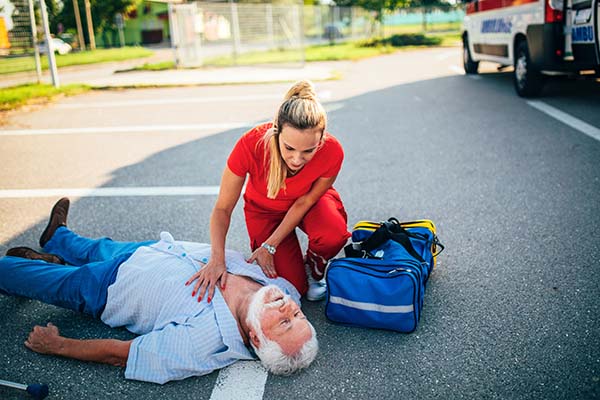 senior man laying on ground experiencing cardiac issue