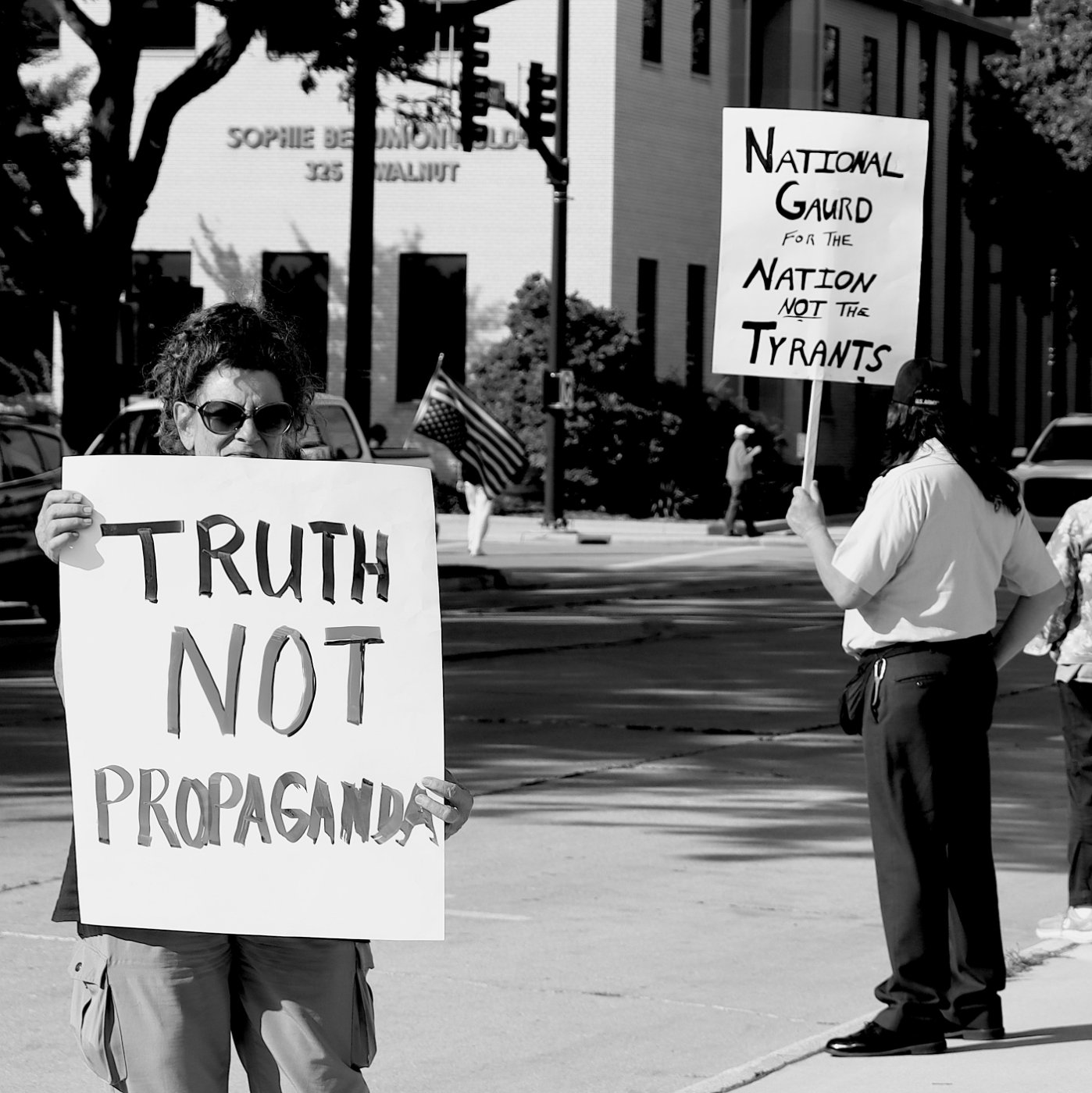 Black and white photo of a pair of protestors with signs.
