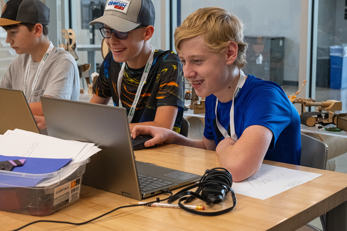 three students working at a computer