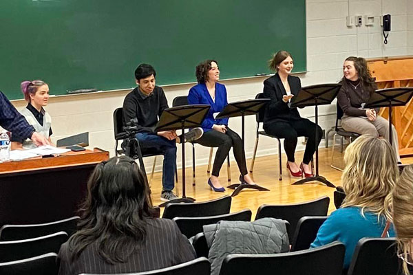 Group of students sitting behind music stands