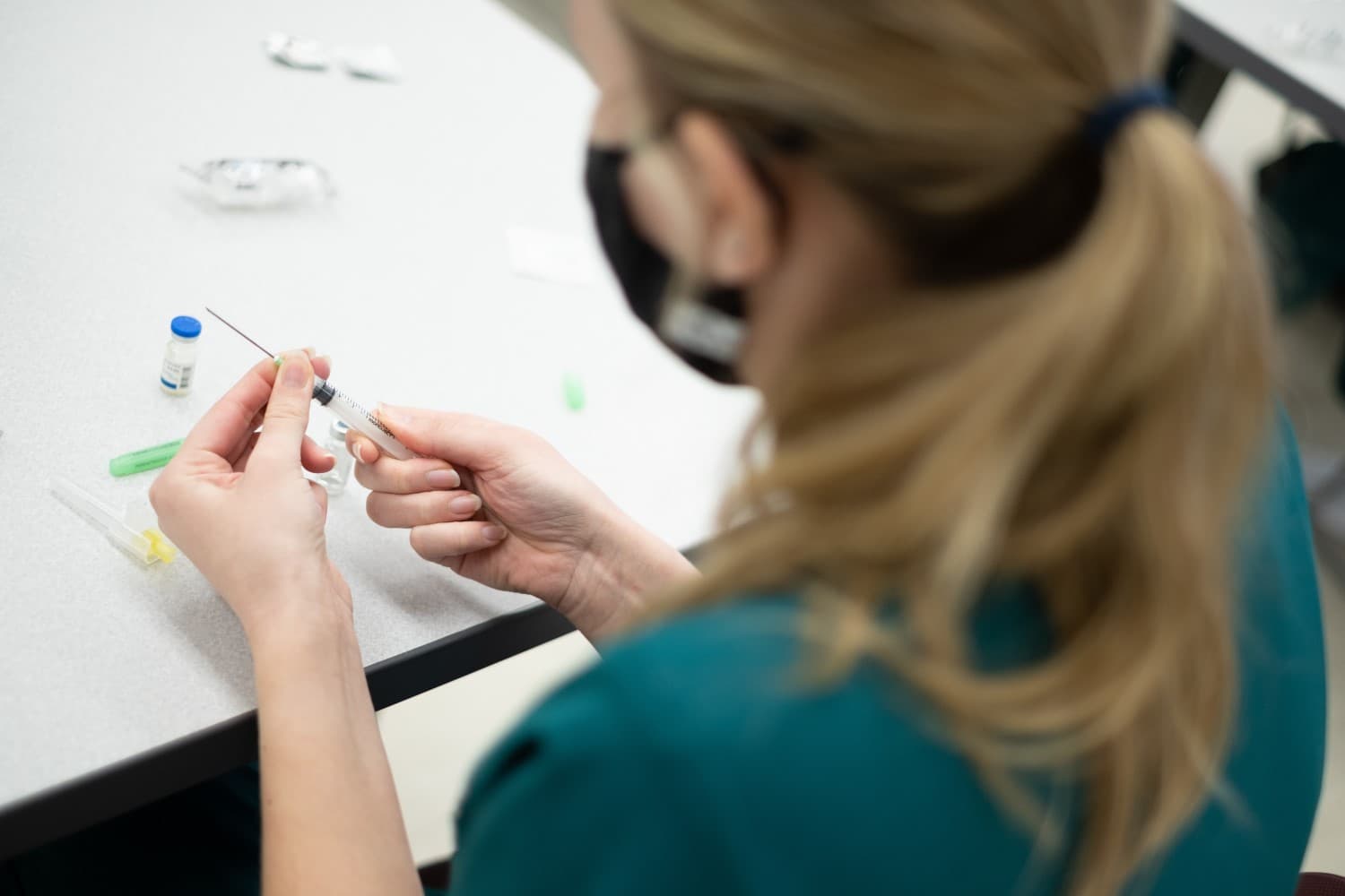 nurse filling syringe with medication