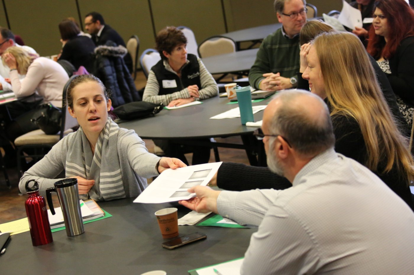 people sitting at a table with a piece of paper