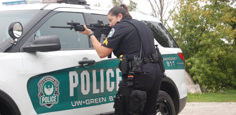 Female police officer holding gun