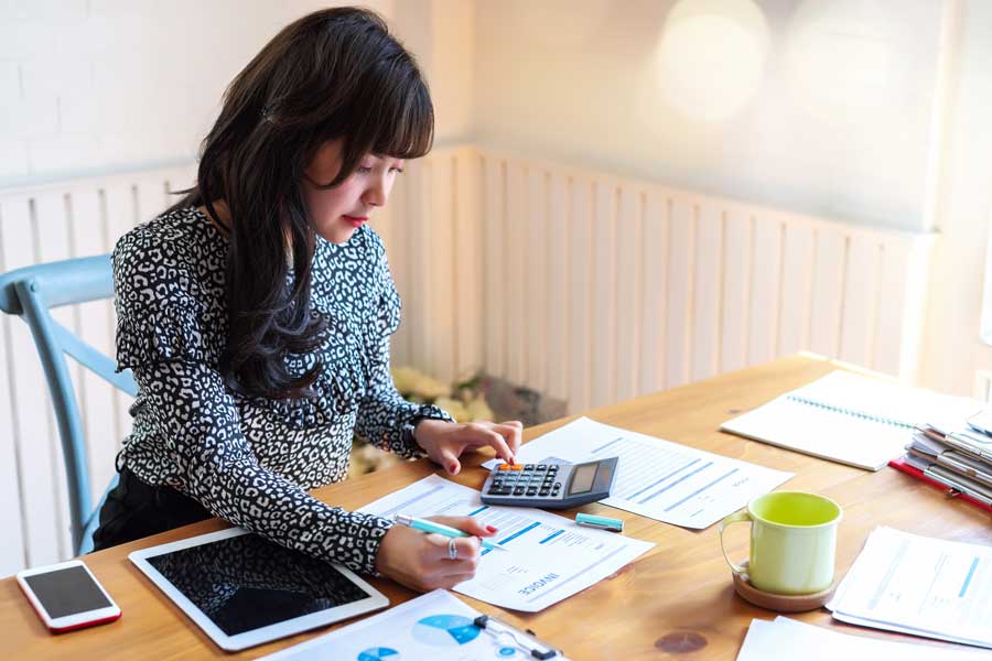 Female works on finances at desk