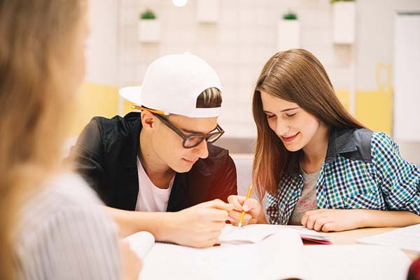 young people in a classroom communicating