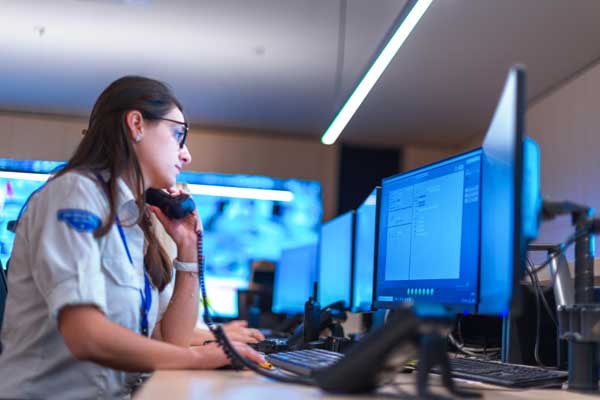 Female employee answers calls while working at computer