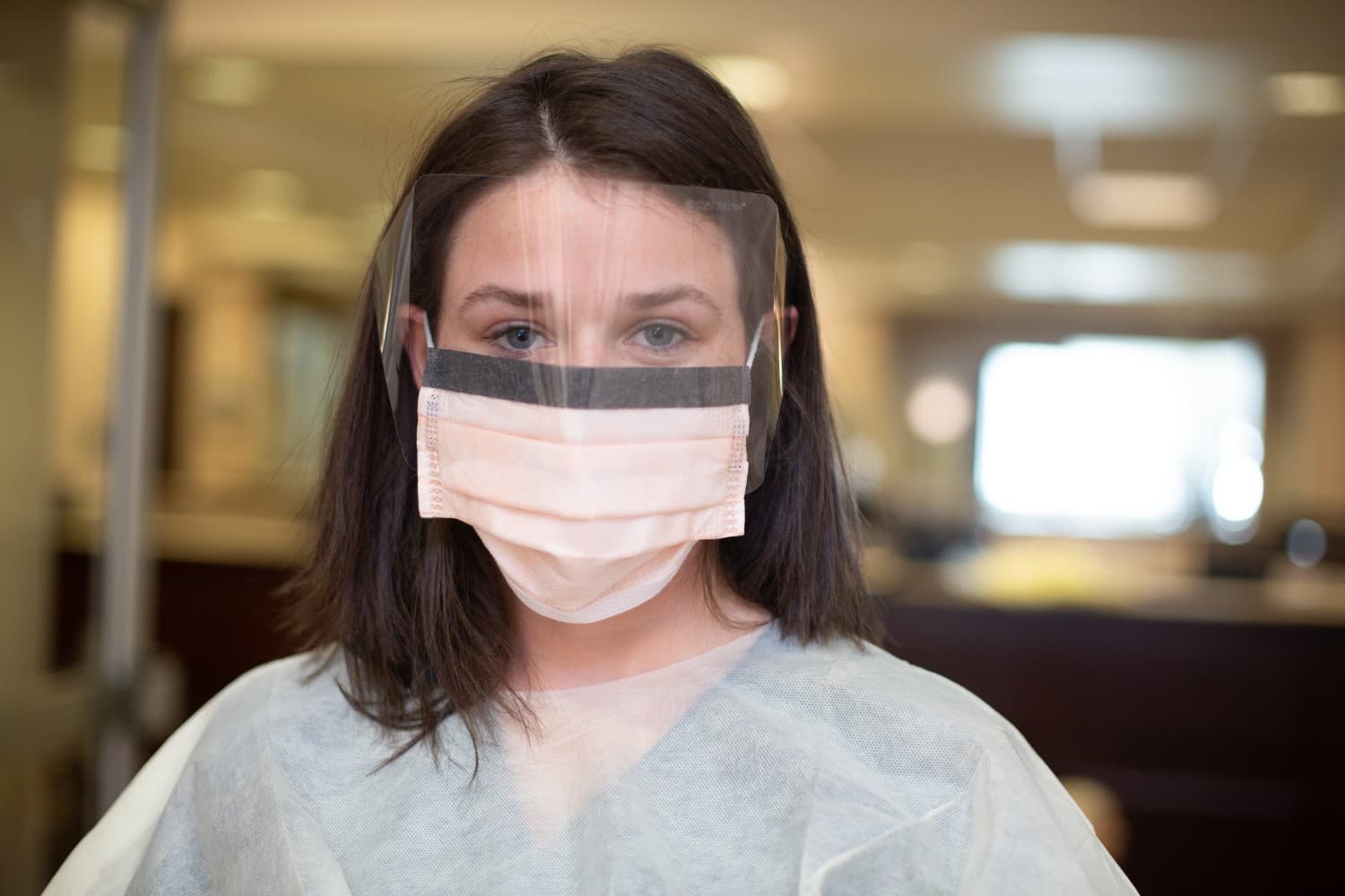 close-up of nurse in mask and PPE