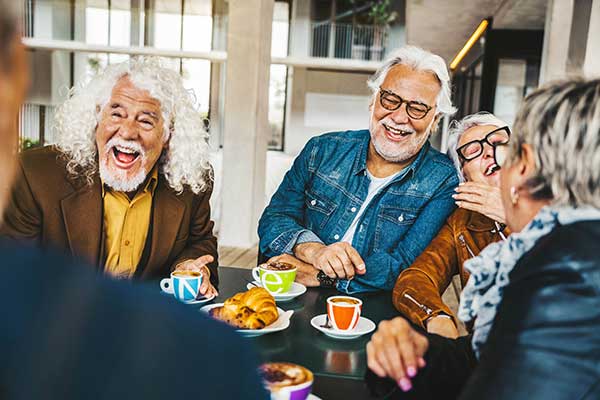 Group laughing at breakfast.