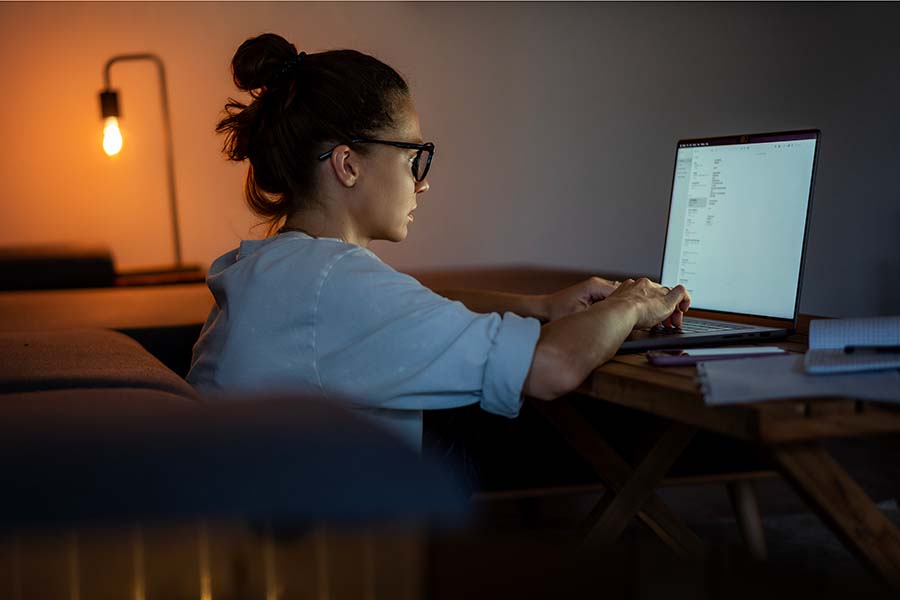 woman working at home on laptop at night
