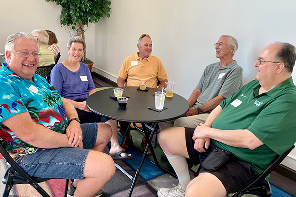 Retirees talking happily around a table