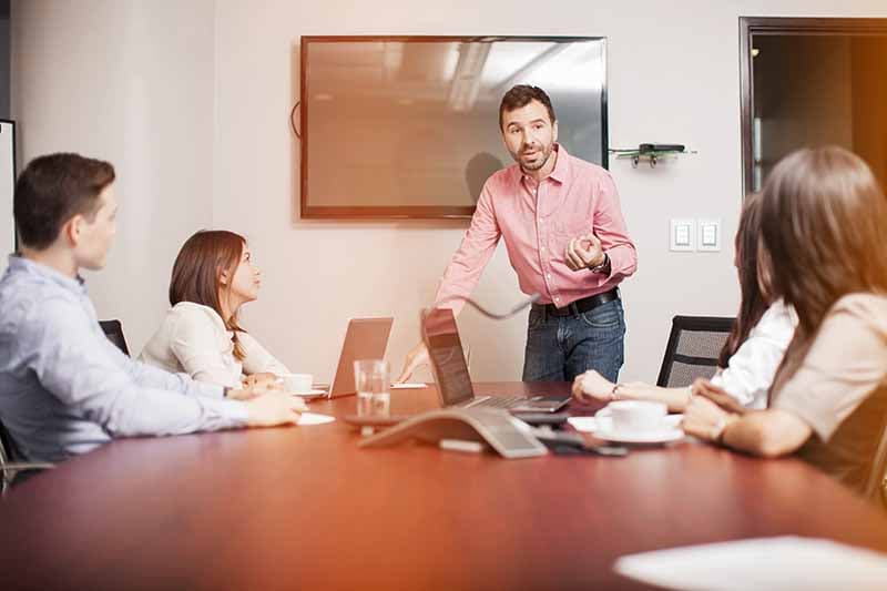 man leading team meeting