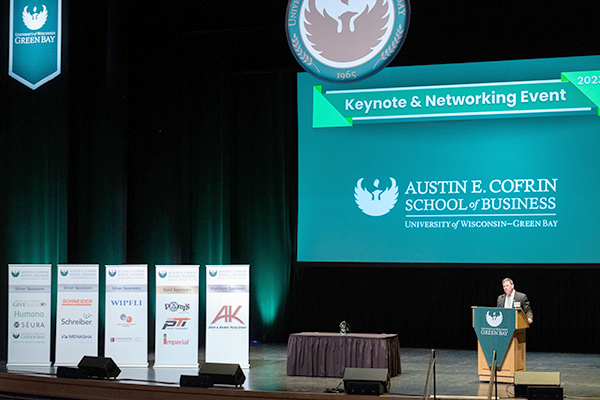 Presenter on stage at Business Keynote Event