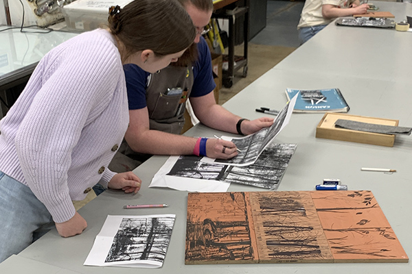 Two students collaborating in print studio