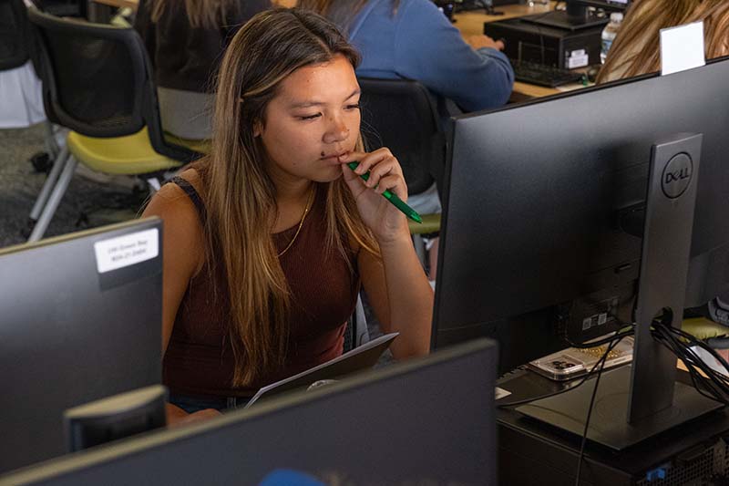 student sitting working on computer