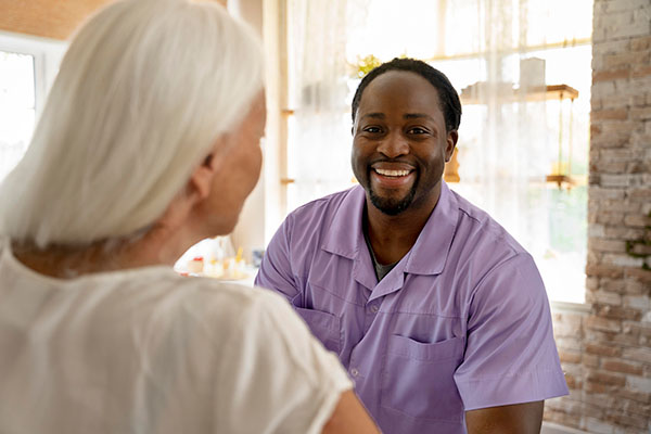 male social worker taking care of senior woman