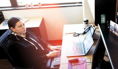 Crystal Lepscier First Nations Student Success Coordinator works on laptop in her office