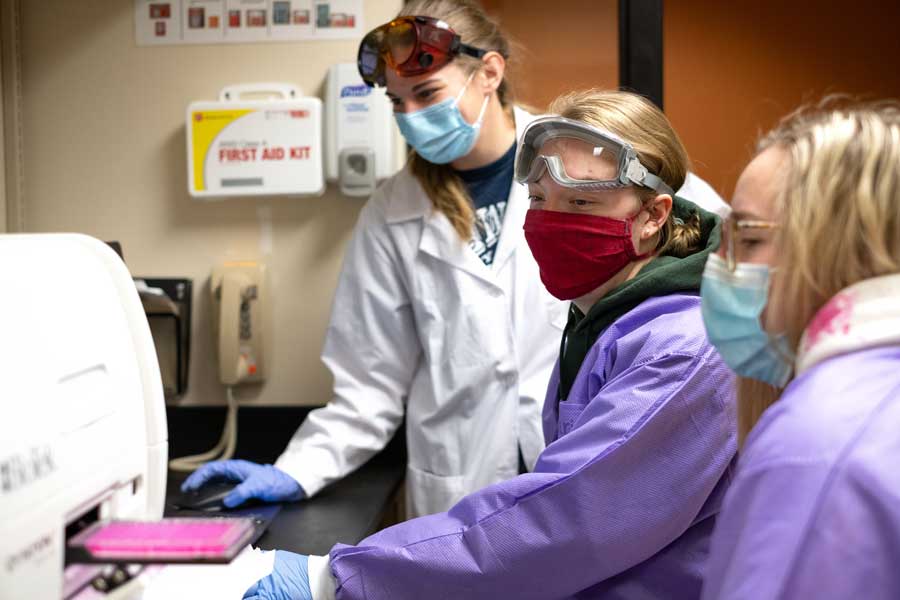 Three female students work in Biology Lab