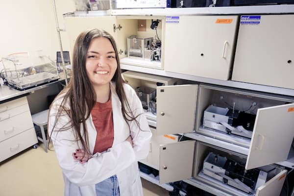 Female student poses for photo in Hillhouse lab