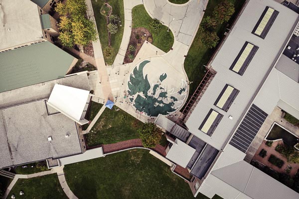 Aerial photo of first-year students painting the phoenix on circle drive