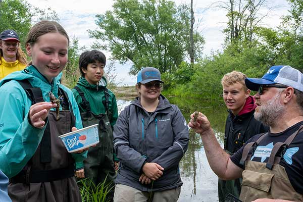 Students and mentor discussing fish.