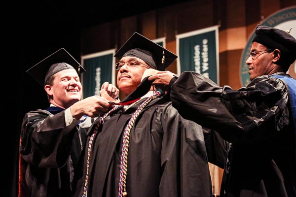 UWGB Master's Program Graduate receiving hood at commencement