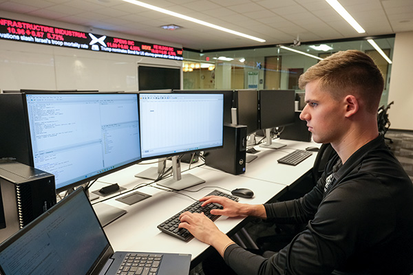 Finance student in classroom, working on computer