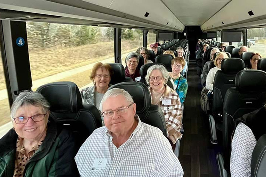Bus seats filled with happy travelers