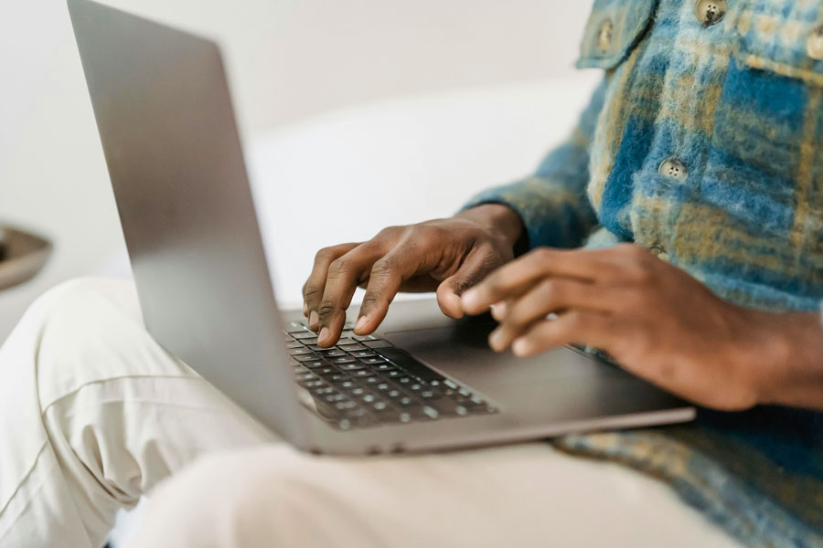 Student typing on laptop