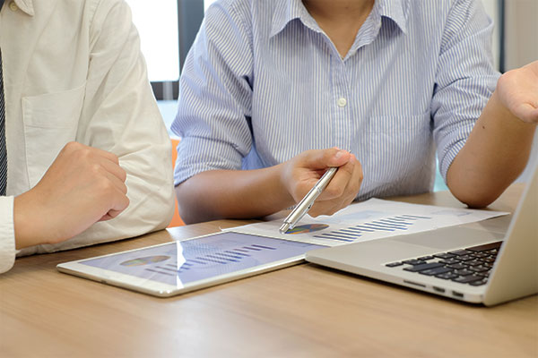 Two people look over collected data from research