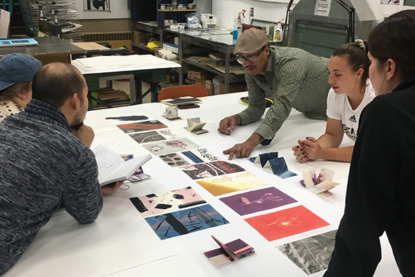 Students critiquing printmaking art