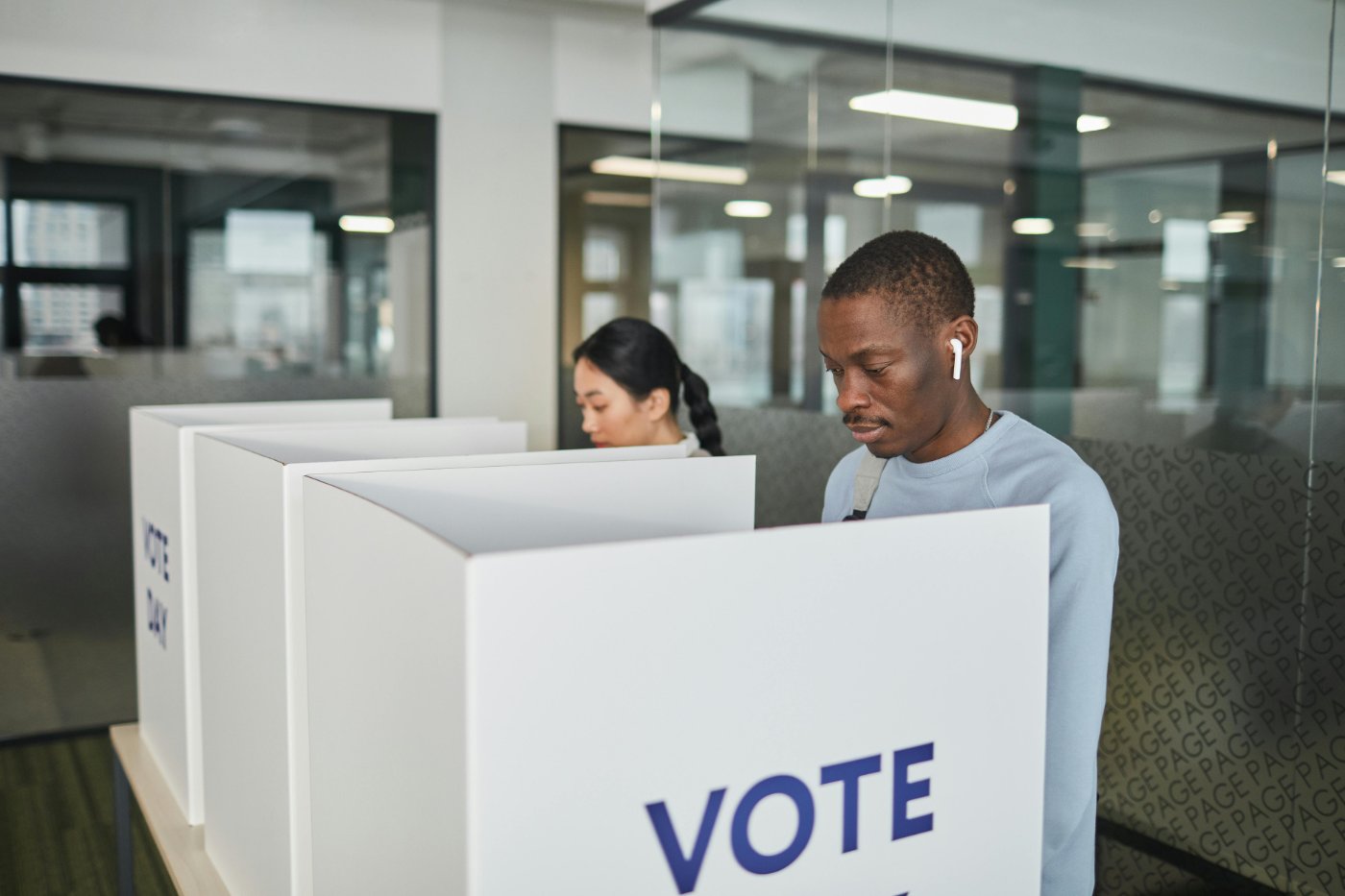 Two people vote at a polling station