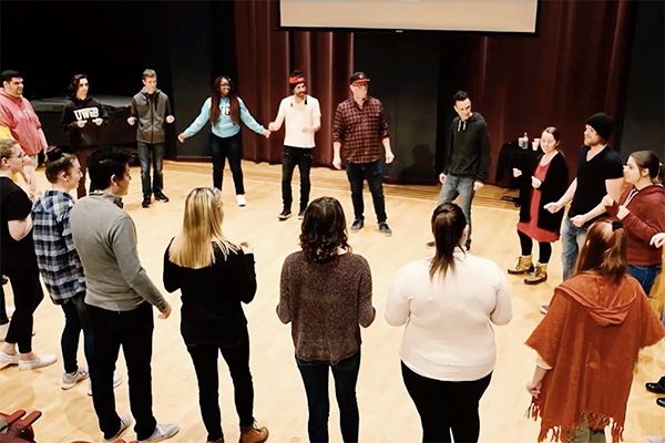 A circle of people on a stage