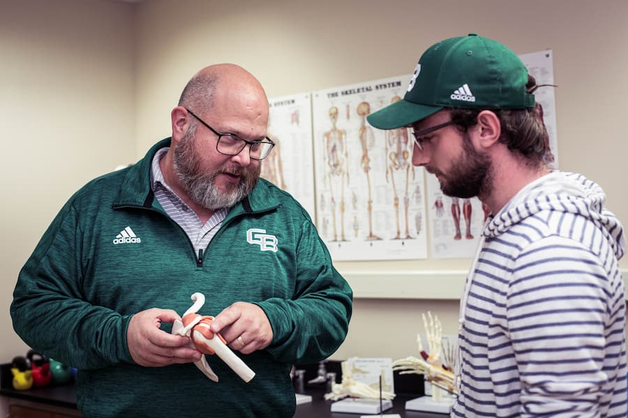 Professor teaches student about anatomy.