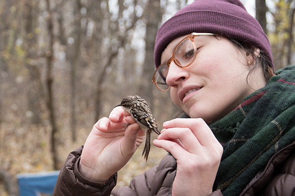 Woman with small bird in her hands