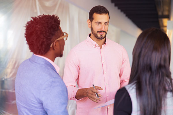 Vendor talking to two conference attendees