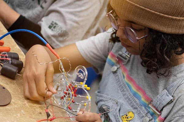 Camper works on robotic parts