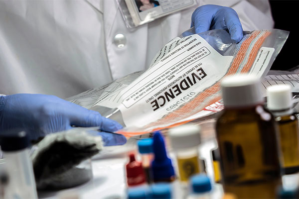 Technician analyzing forensic evidence in a crime lab.