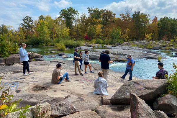 Geoscience group studying by river