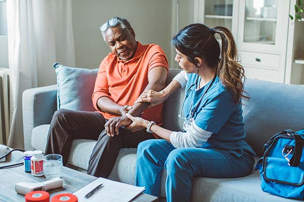 senior man being helped by caregiver