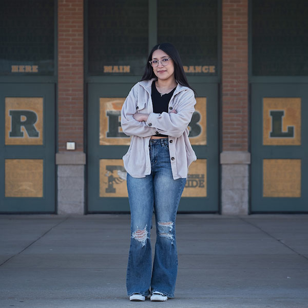 Vanessa standing outside of Preble High School doors