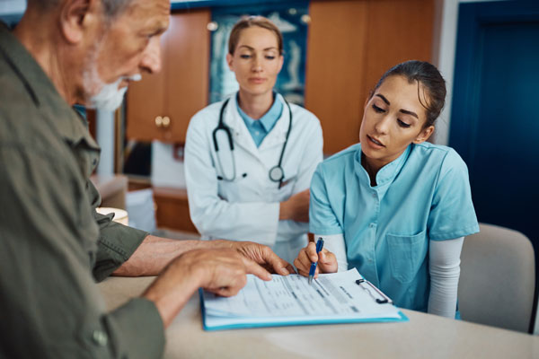 Doctor and nurse consult with patient